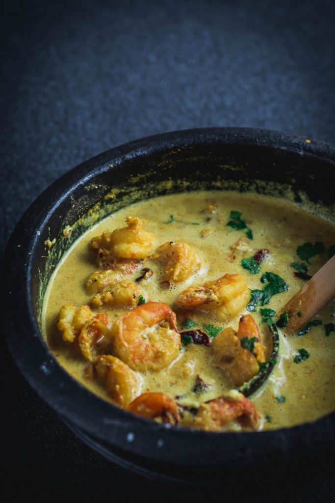 Goan prawn curry in black earthenware pot