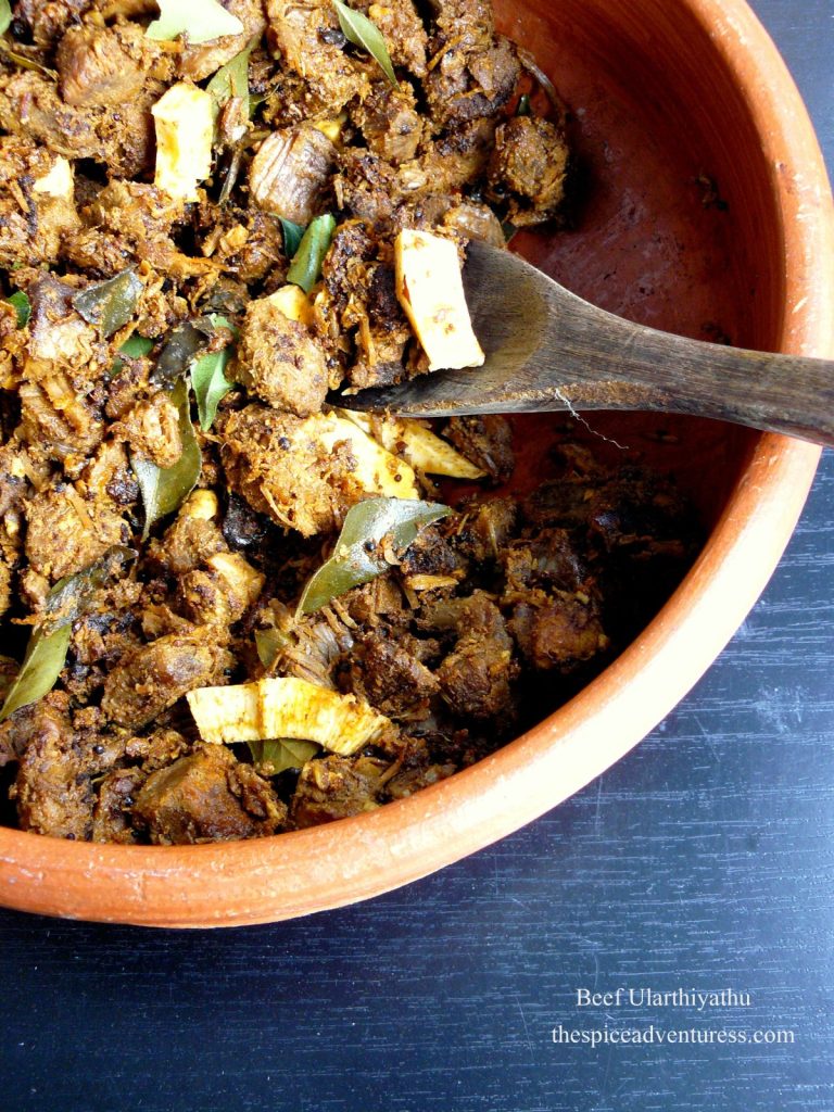 Indian style beef fry with coconut in terracotta bowl