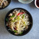 Noodles with mushroom and chicken in a black bowl