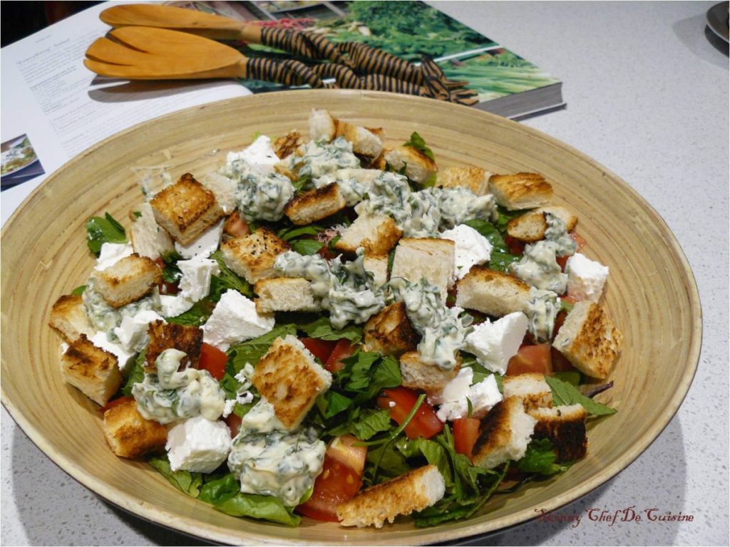 Mixed salad with bread croutons in wooden salad bowl