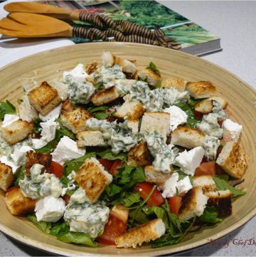 Mixed salad with bread croutons in wooden salad bowl