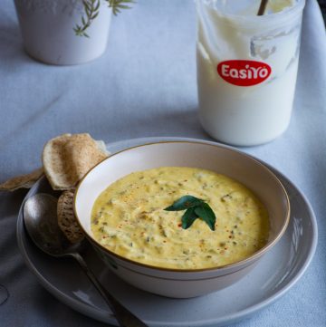 Indian yoghurt dip served in white bowl and placed on a grey plate