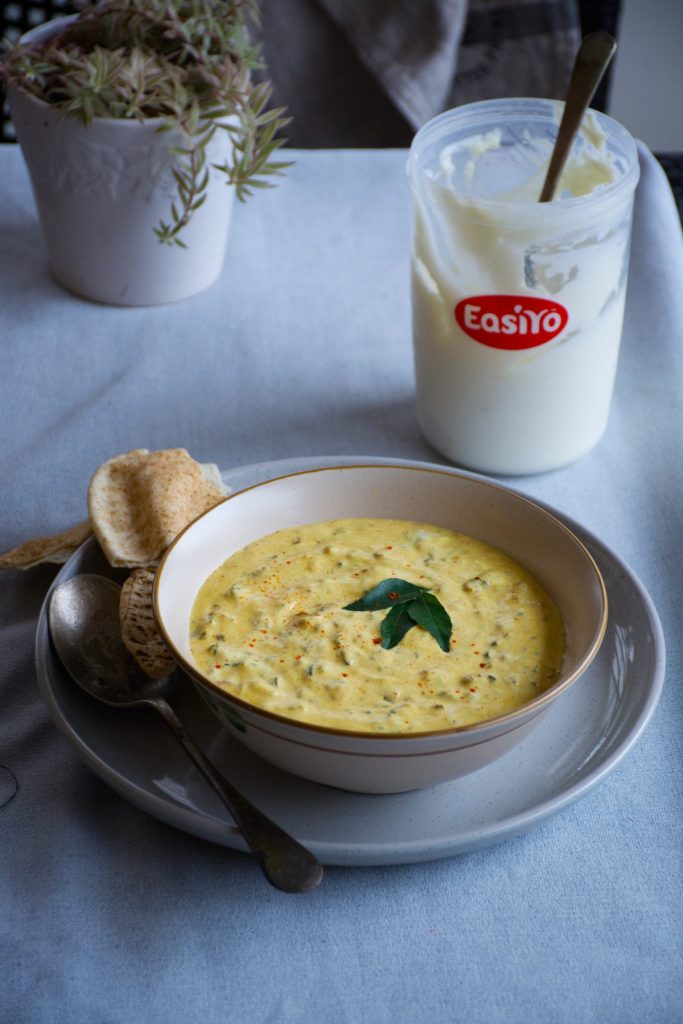 Indian yoghurt dip served in white bowl and placed on a grey plate