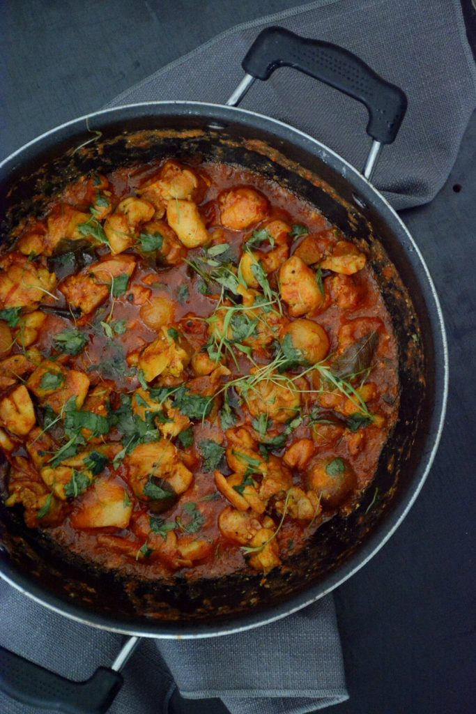Indian chicken curry in black pan