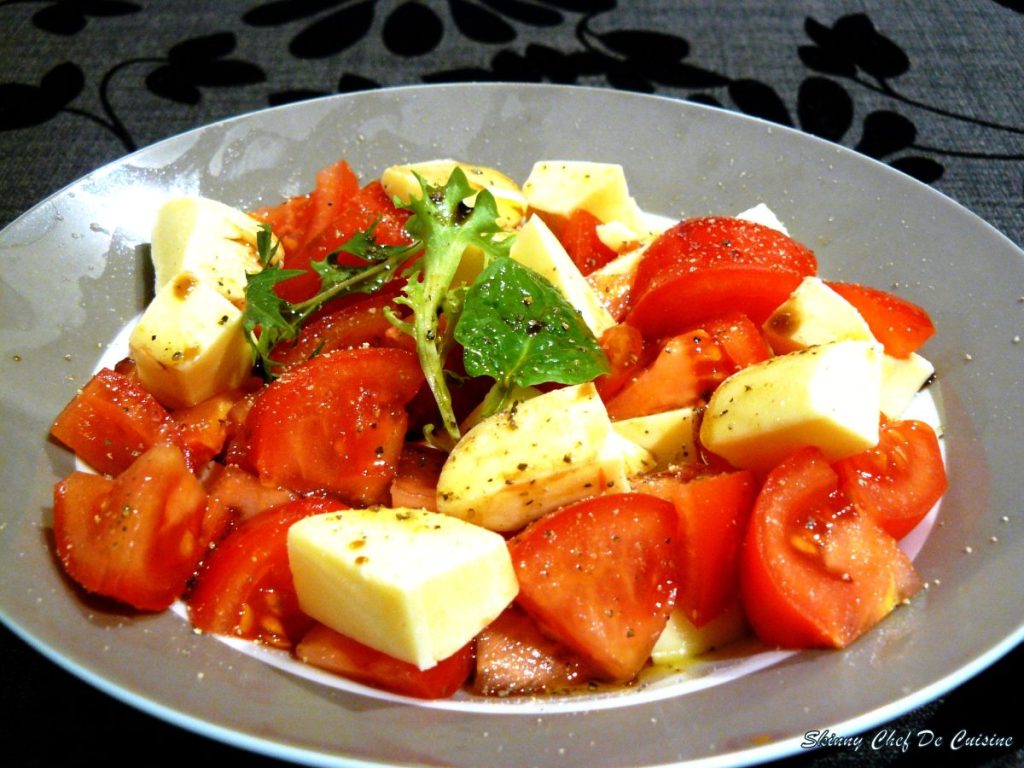 Tomato and cheese salad served in grey plate