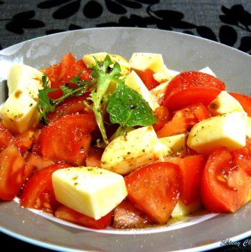 Tomato and cheese salad served in grey plate