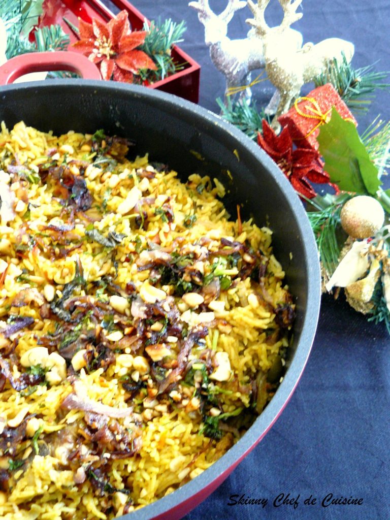 Lamb biryani served on grey plate with Christmas decorations in the background