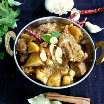 Indian pork curry served in steel bowl