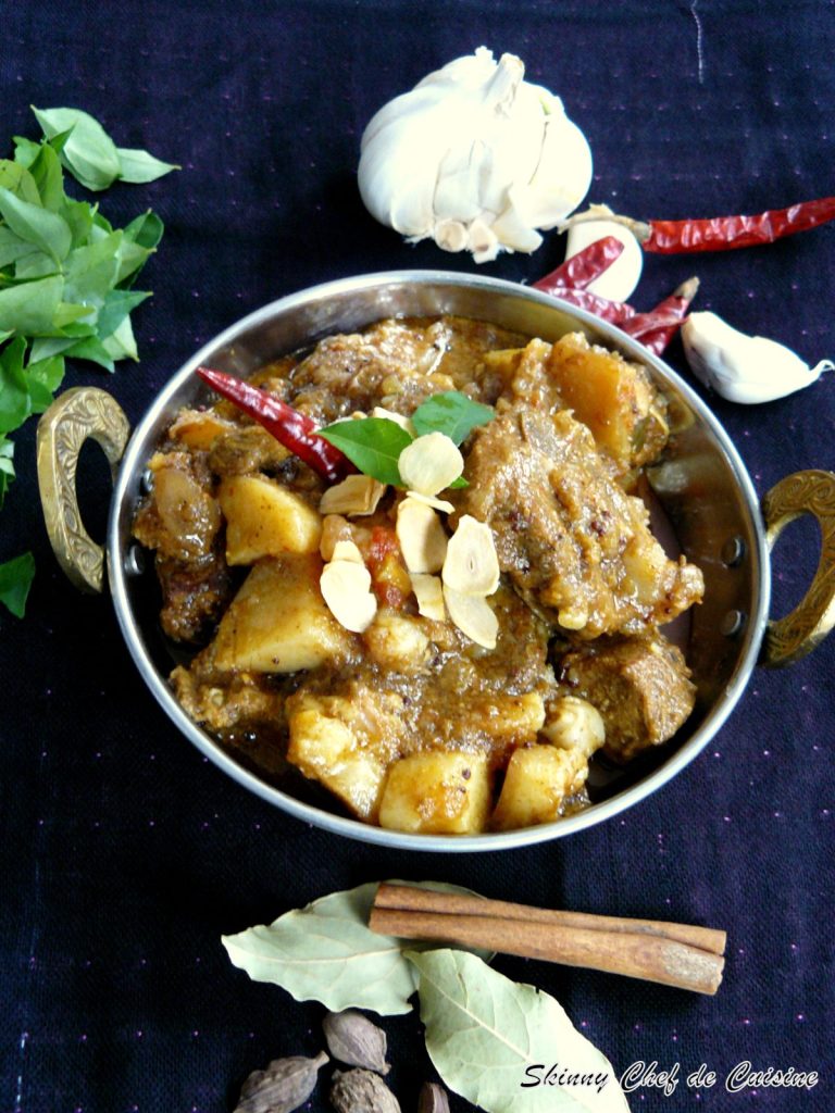 Indian pork curry served in steel bowl