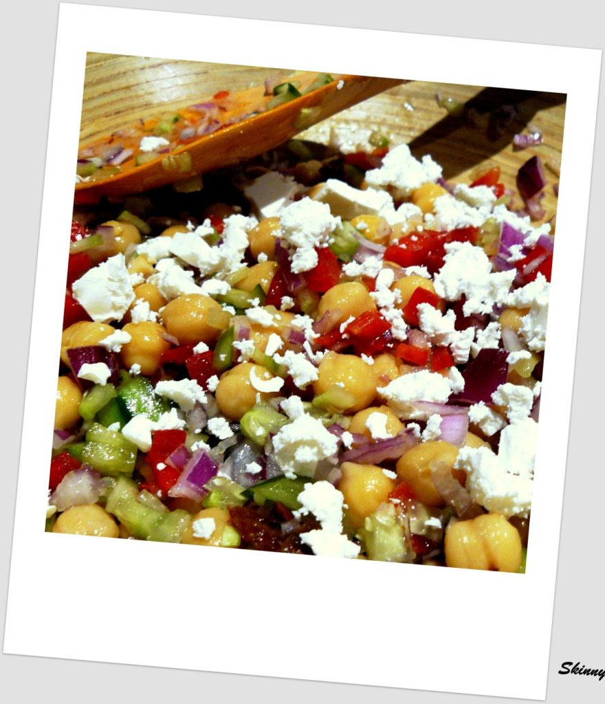 Chickpea salad with vegetables and feta cheese sprinkled on top