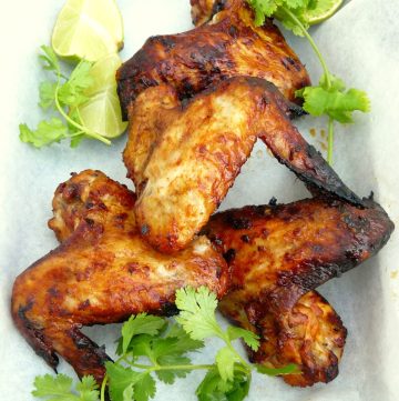 Grilled chicken wings garnished with coriander leaves
