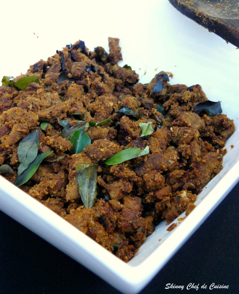 Indian style beef fry with spices and curry leaves in white bowl