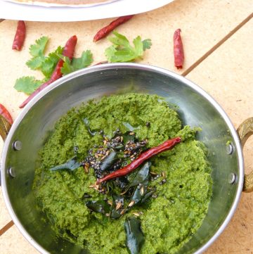 Coriander chutney garnished with spices and chillies
