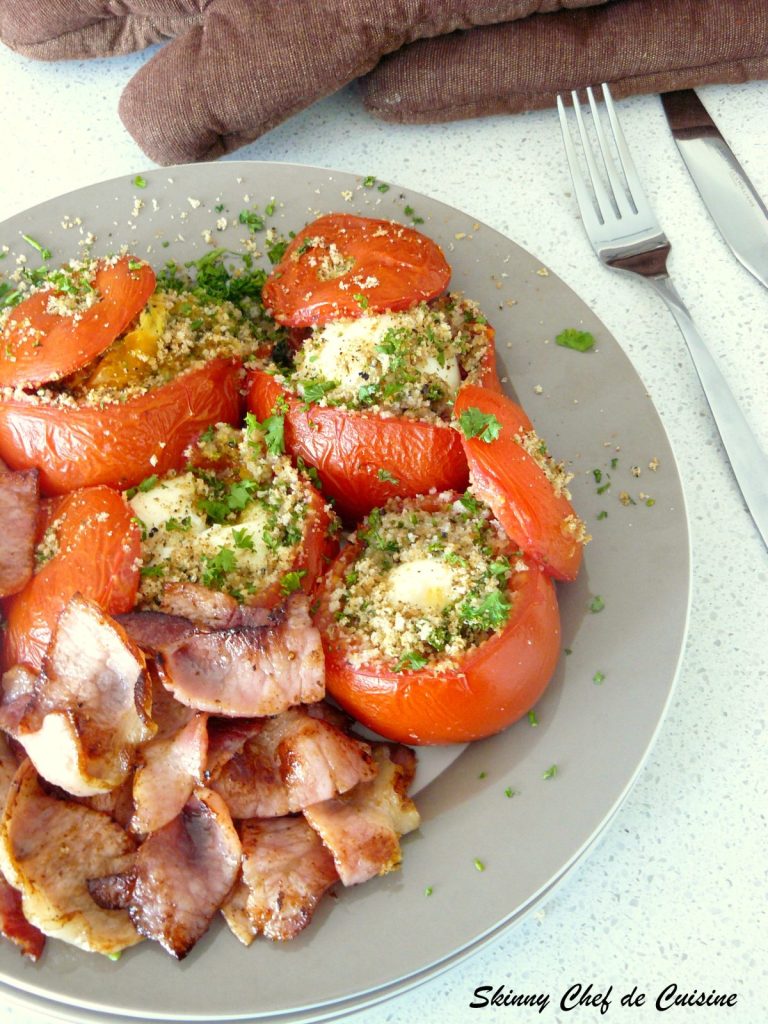 Baked eggs in tomatoes served with bacon