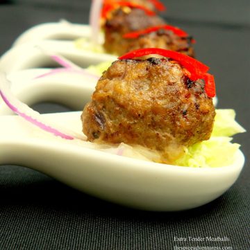 Individual meatballs served in small white spoons