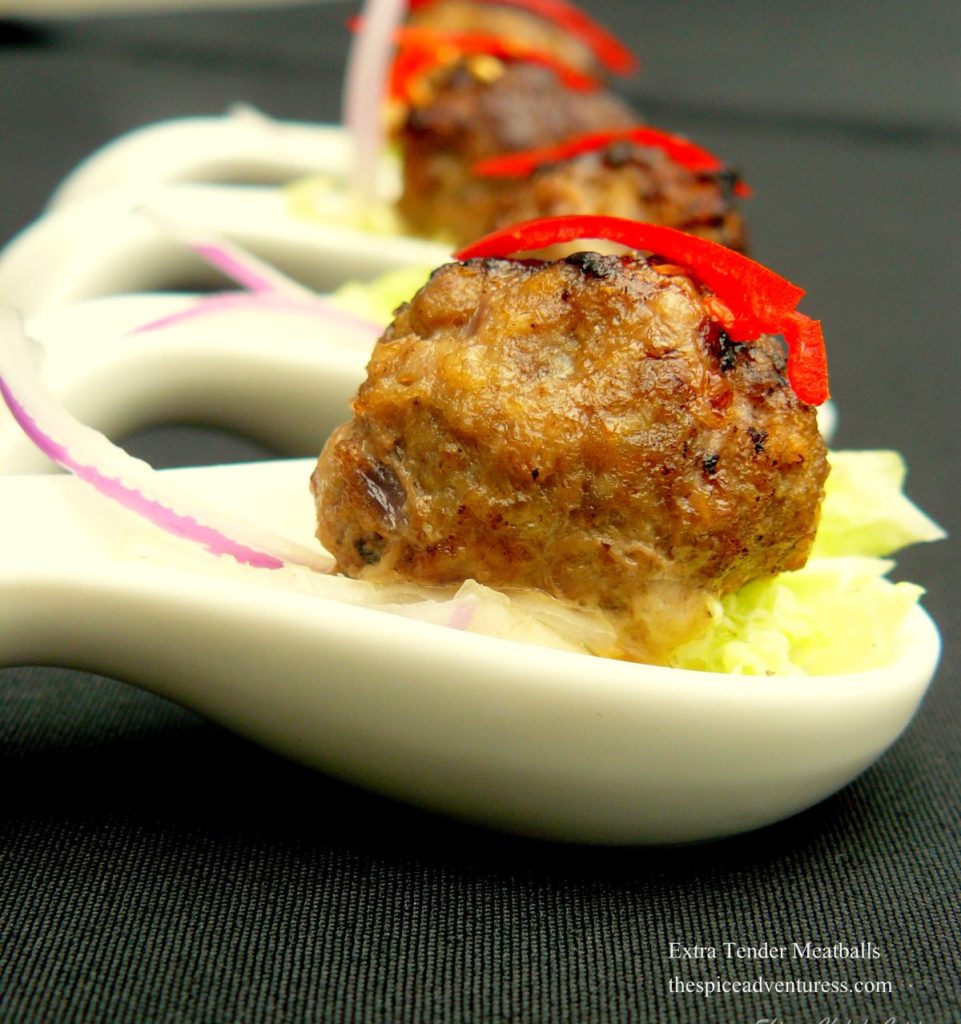 Individual meatballs served in small white spoons