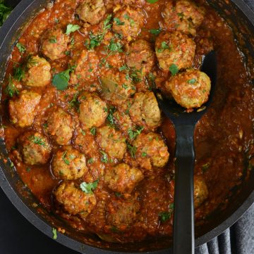 A black pan with lamb meatball curry