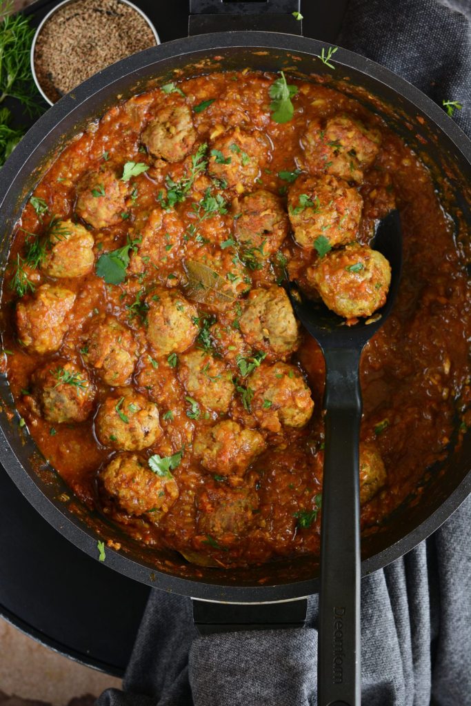 A black pan with lamb meatball curry