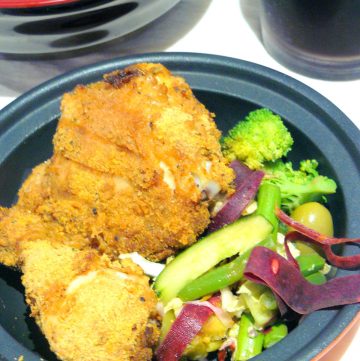 Fried chicken pieces and salad in bowl