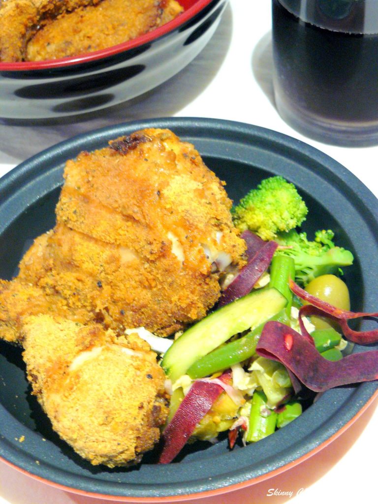 Fried chicken pieces and salad in bowl