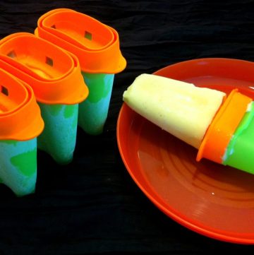 Mango popsicles in orange and green containers