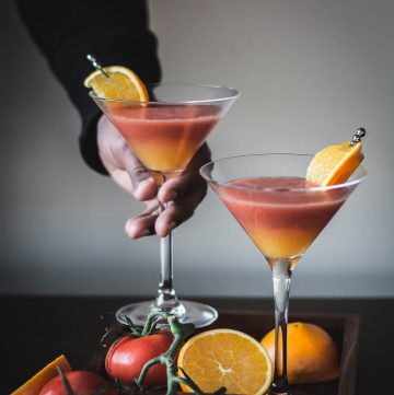 two glasses of tomato and orange drink