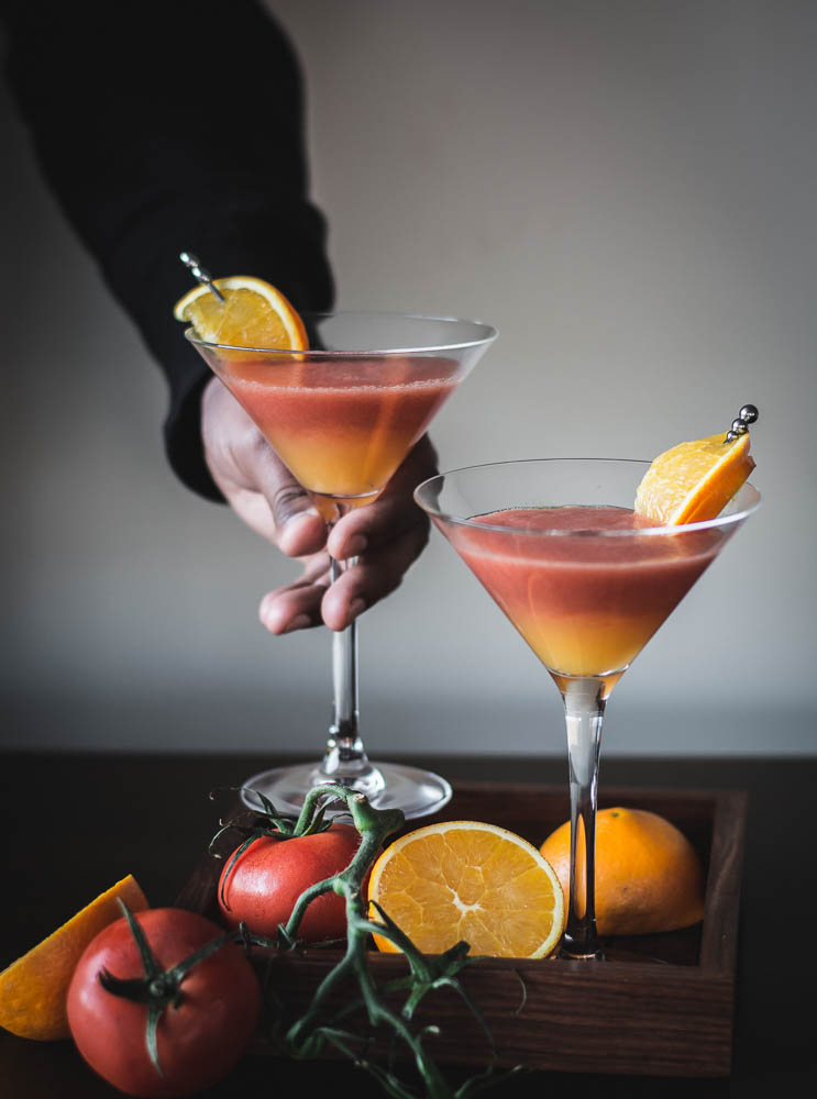 two glasses of tomato and orange drink