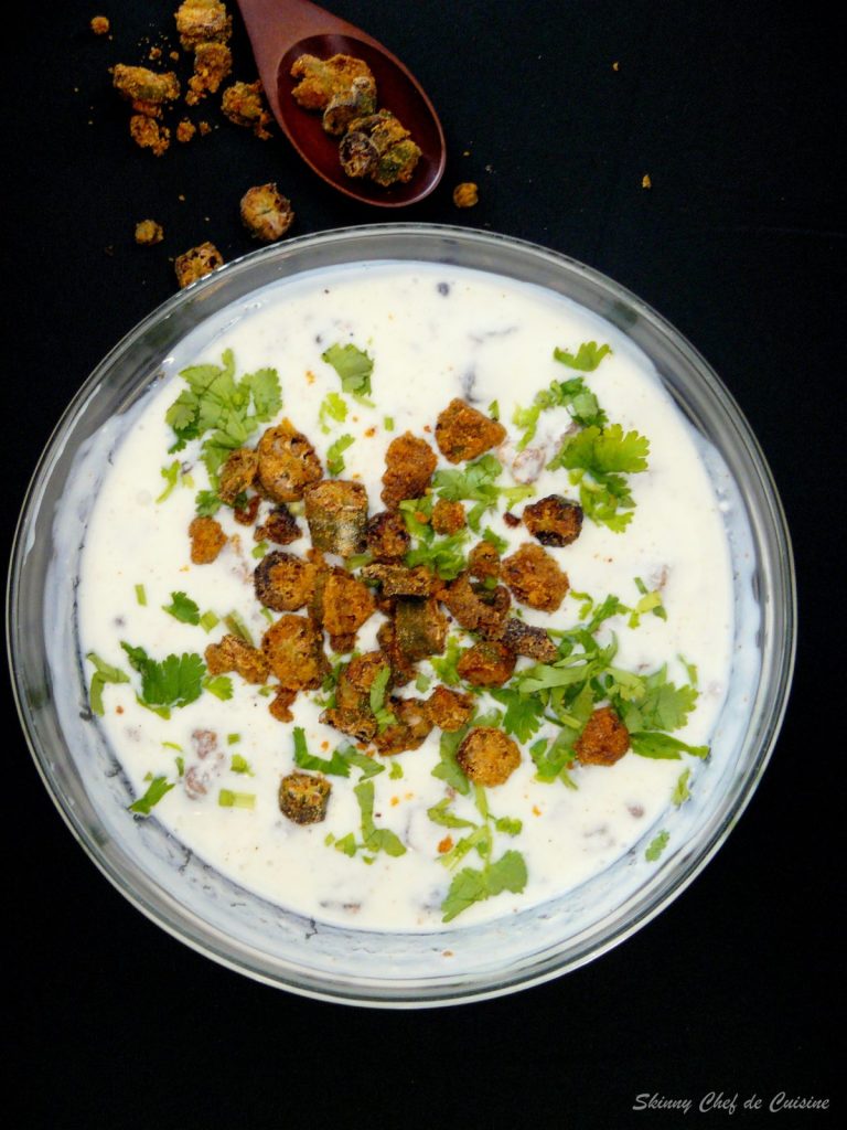 Yoghurt dip with fried okra served in glass bowl