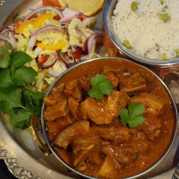 Indian pork curry served with rice and salad