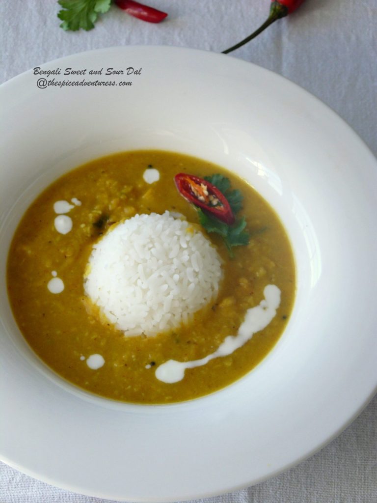 Yellow lentil curry served with rice in white bowl