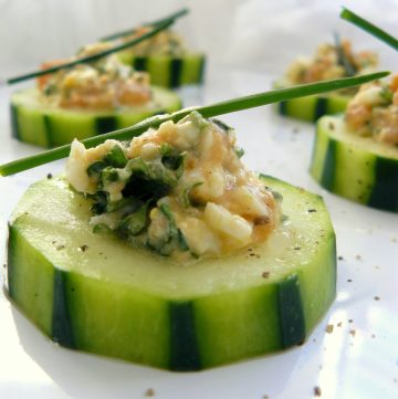 Close up of stuffed cucumber salad garnished with chives