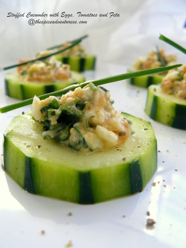 Close up of stuffed cucumber salad garnished with chives