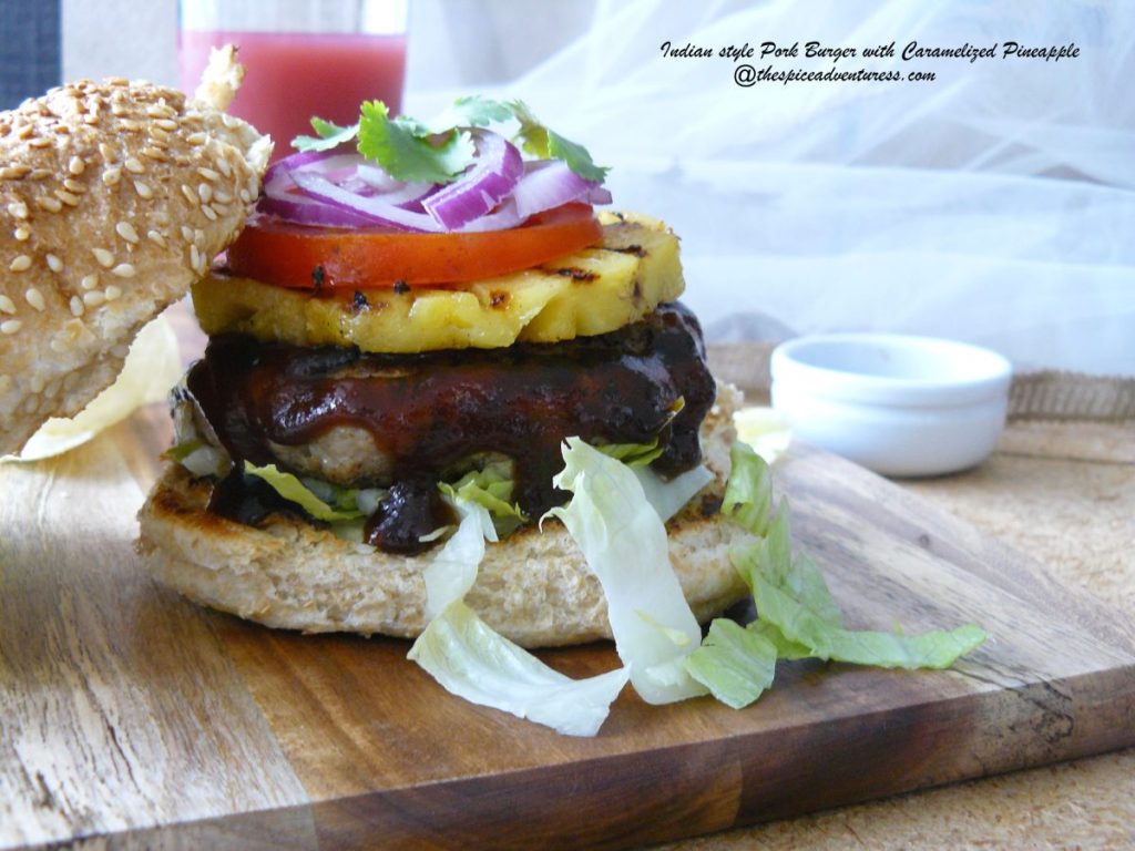 Open view of pork burger with pineapple