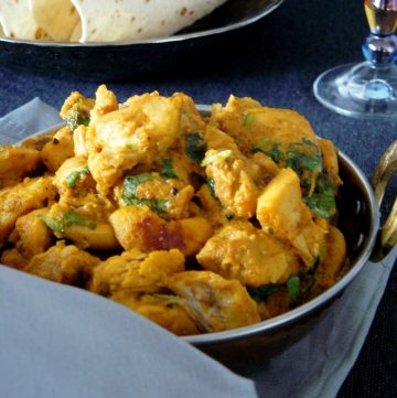 Indian style chicken curry in copper bowl