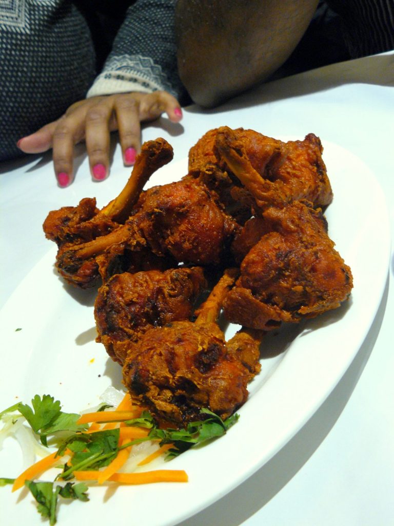 Fried chicken drumstick on white plate