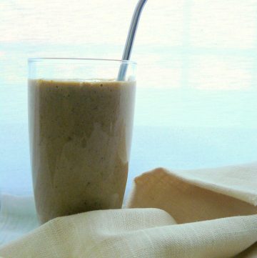 One glass of banana coffee smoothie with a spoon inside