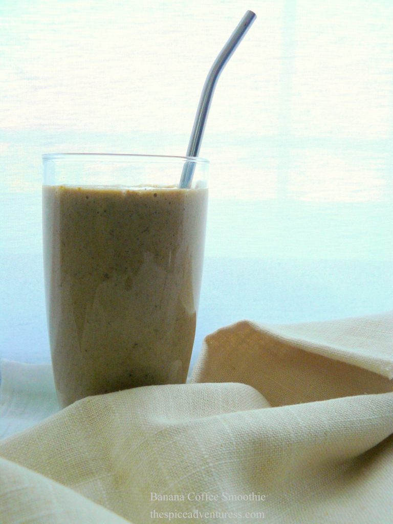 One glass of banana coffee smoothie with a spoon inside