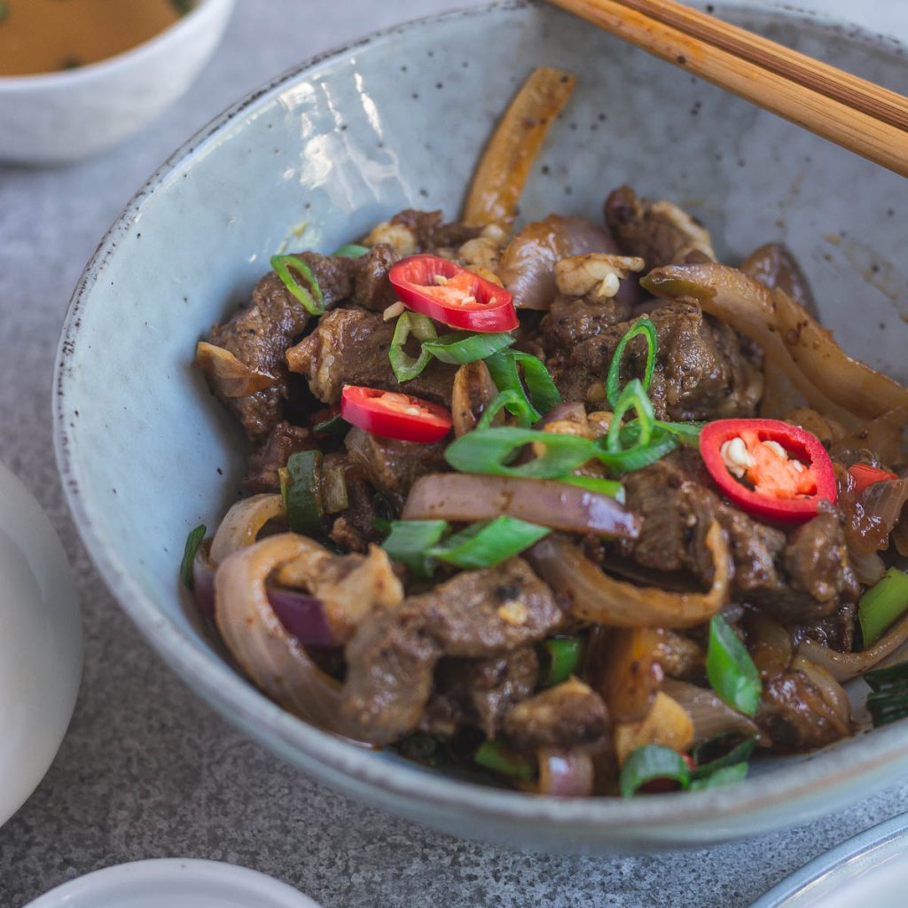 lamb fry with spices in blue bowl