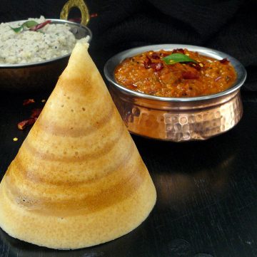 Cone shaped rice crepe and tomato egg chutney on the side