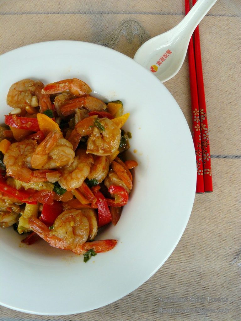 Prawns stir fry with capsicum served in white plate