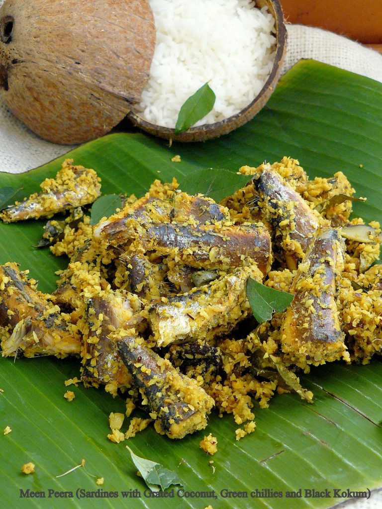 Indian style sardines with grated coconut served with rice on banana leaf