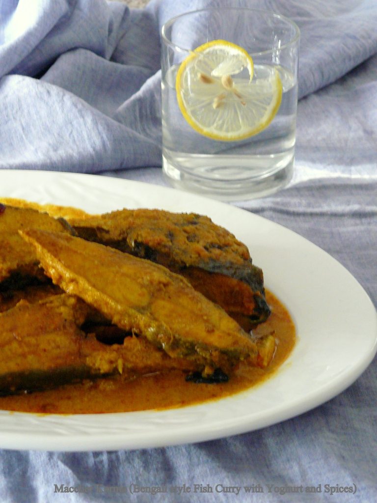 Indian style fish curry in white plate