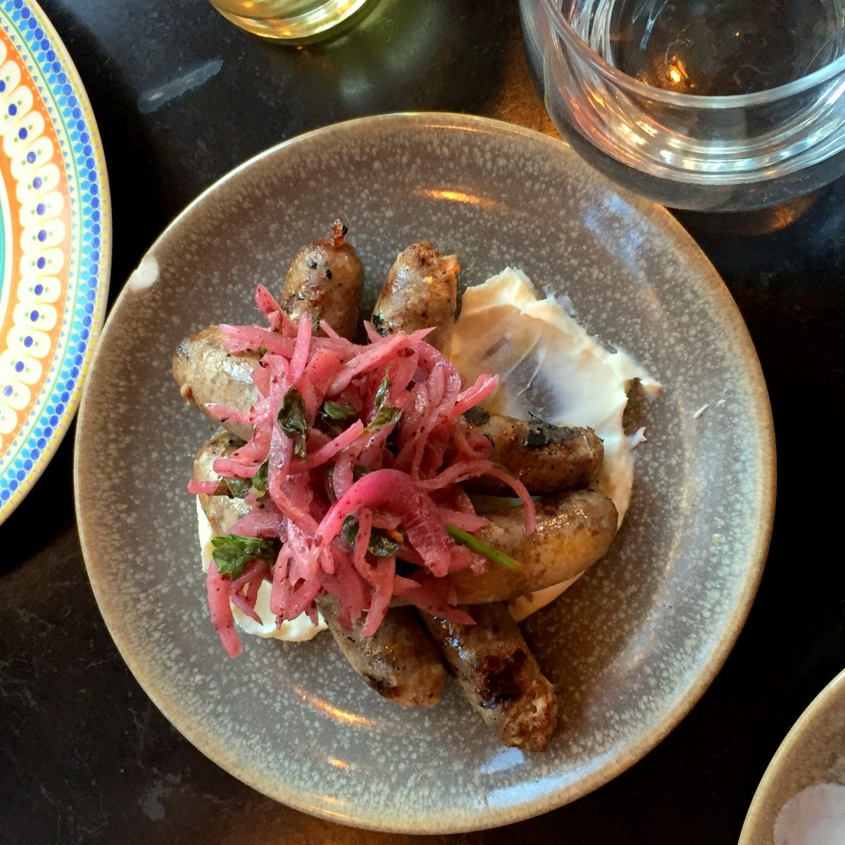 Makaneh sausage with tahini labneh and pickled onions