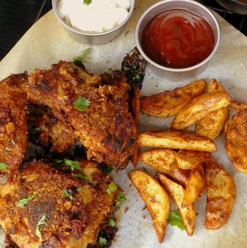 Fried chicken pieces, potato wedges, mayo and tomato sauce