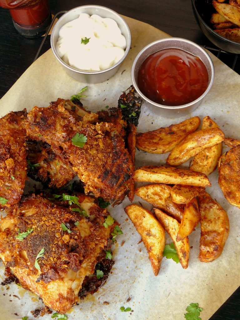 Fried chicken pieces, potato wedges, mayo and tomato sauce
