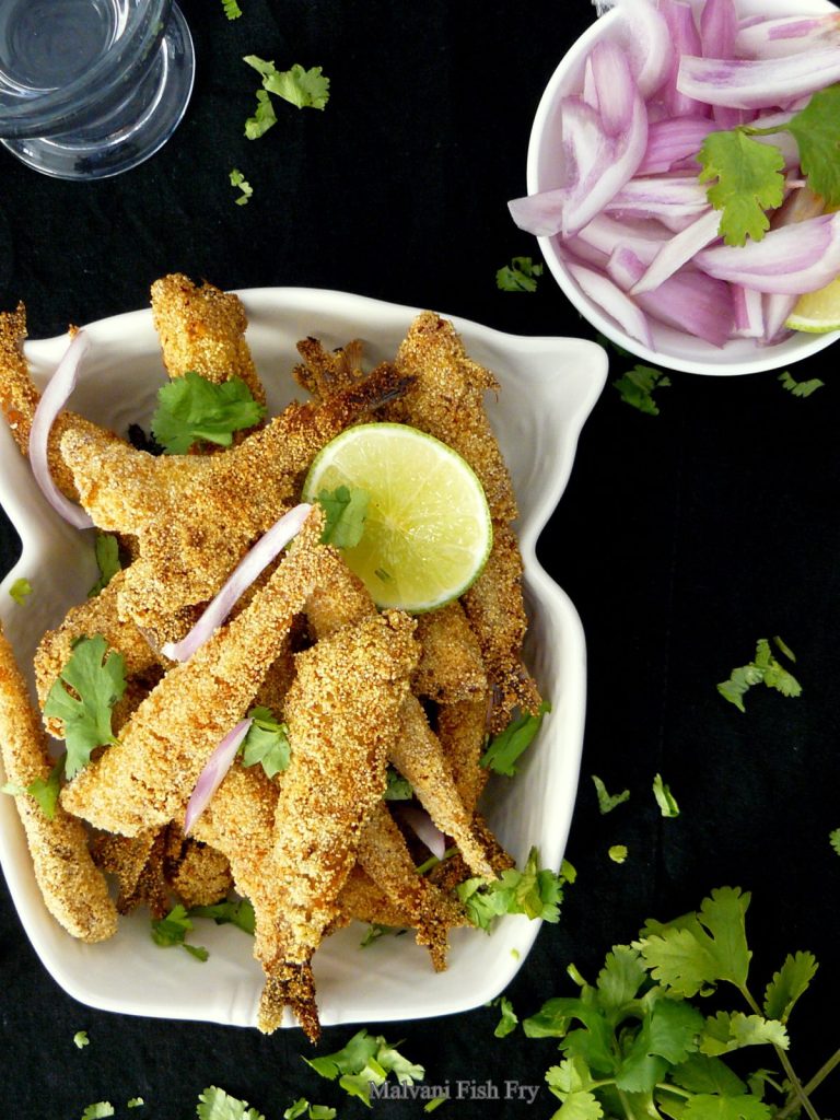 Indian style small whole fried fish served in white bowl