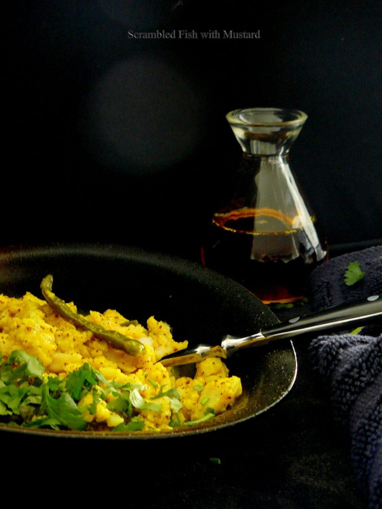 Indian style scrambled fish in black bowl