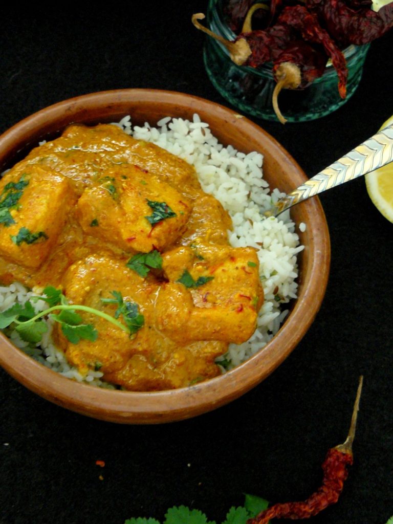 Indian fish curry served over rice in a bowl
