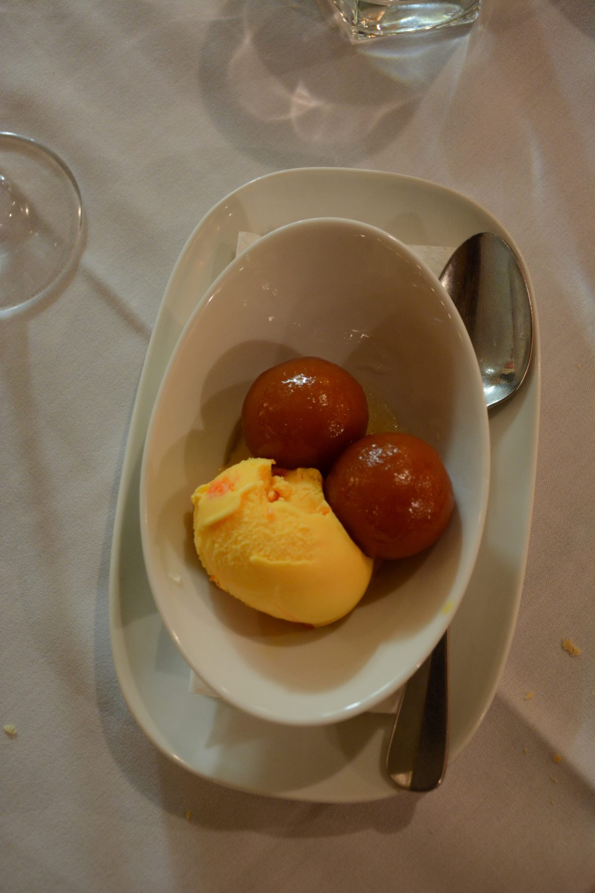 Gulab jamuns (dumplings in golden sugar syrup) with mango ice-cream