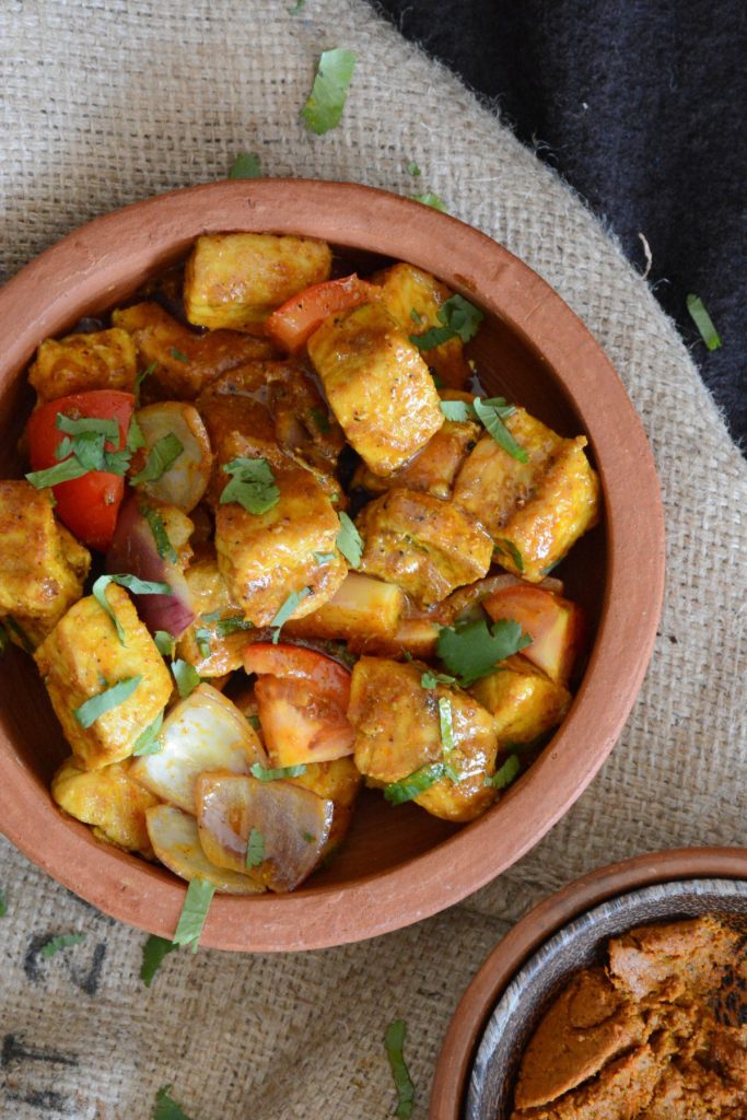 Fried shark curry in terracotta bowl